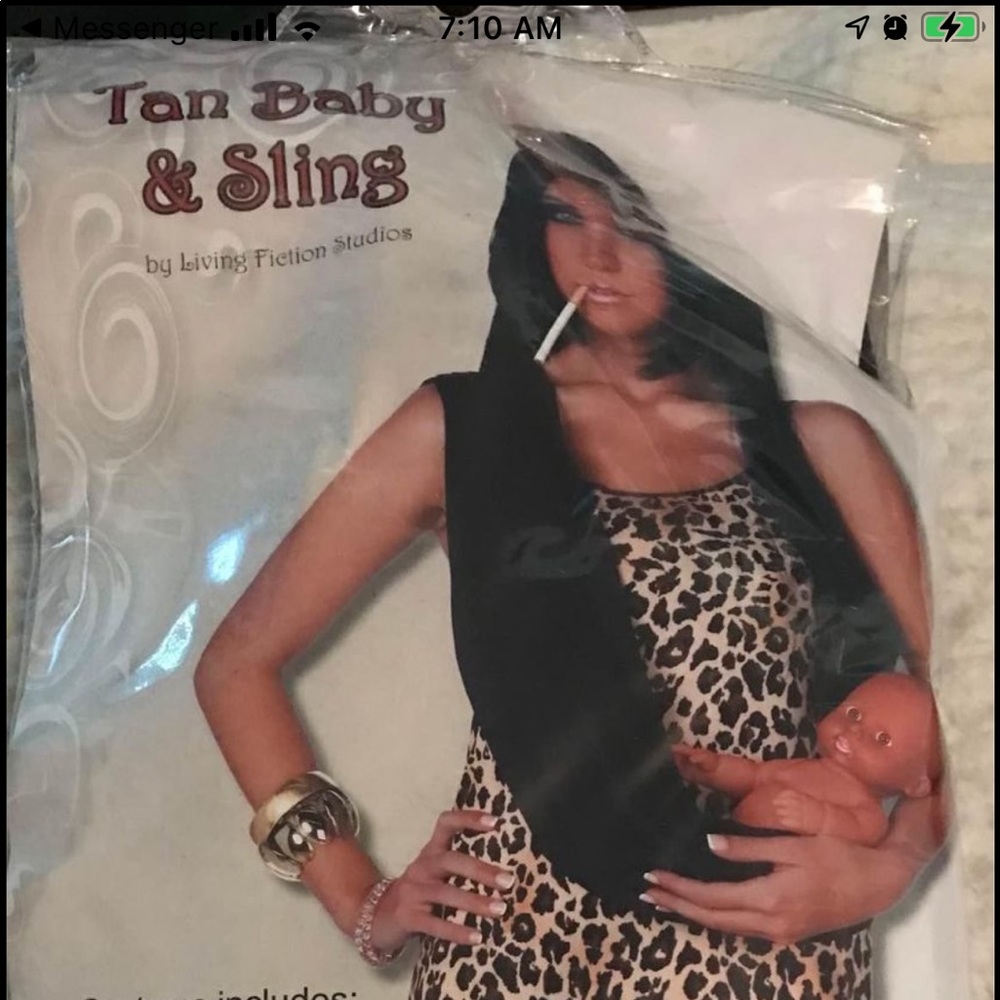 Dark skinned babydoll in sling and fake bone through head accessories.  …